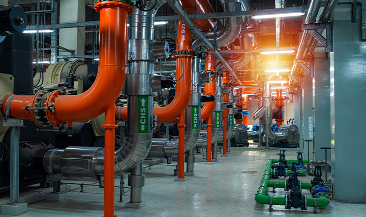 Industrial piping and valves in a commercial heating system installation.