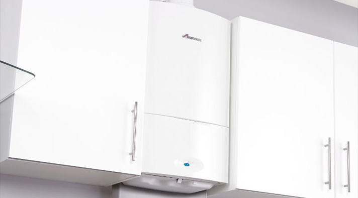 White gas boiler installed in kitchen cabinetry, showcasing professional boiler installation services.