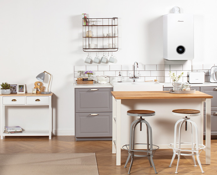 Modern kitchen with a wall-mounted boiler and stylish stools.